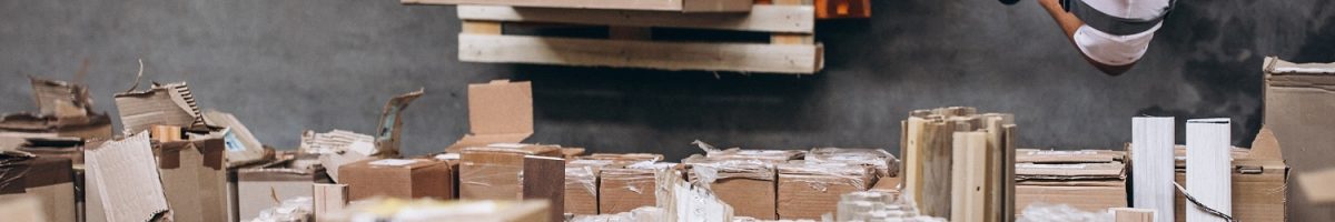 Young man working at a warehouse with boxes